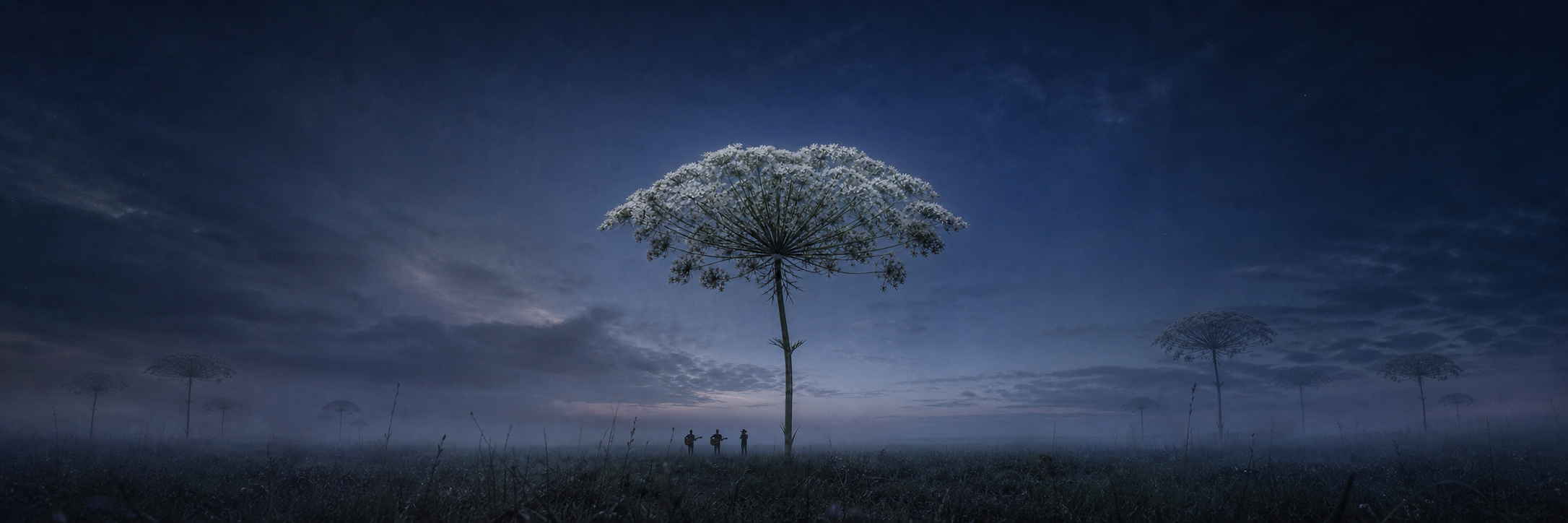 A colossal umbel rising over three people in a moonlit landscape, with distant umbel groves revealed to either side